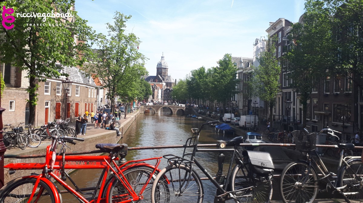 View of Amsterdam canals and Dutch bikes on a bridge