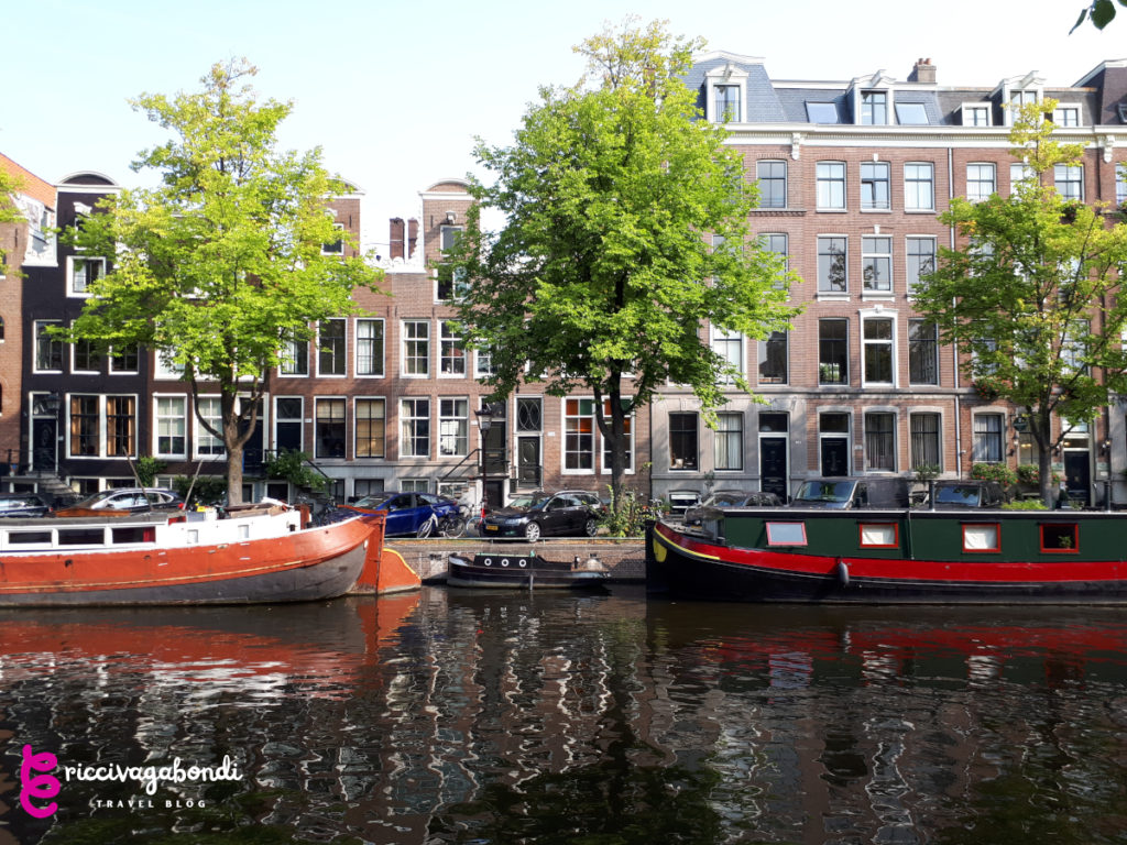 View of Amsterdam canals with boots and red bricks houses
