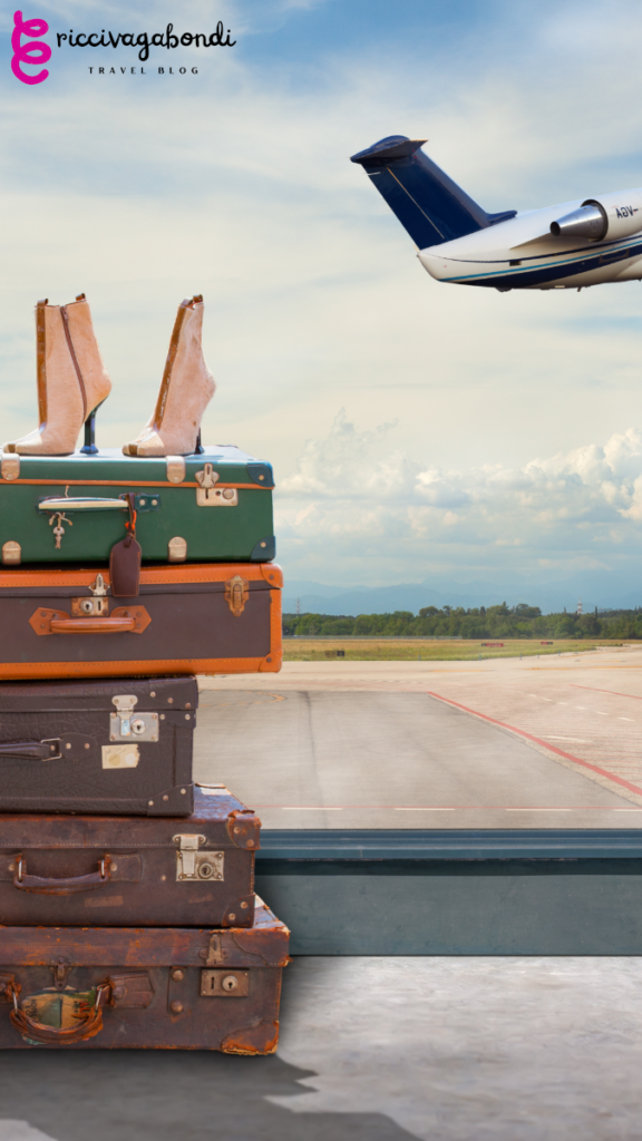 View of vintage luggages with boots on it and a plane in the background