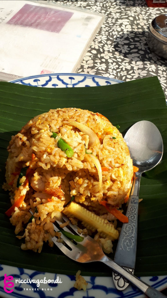 Asian rice with vegetable served on a bamboo leash.