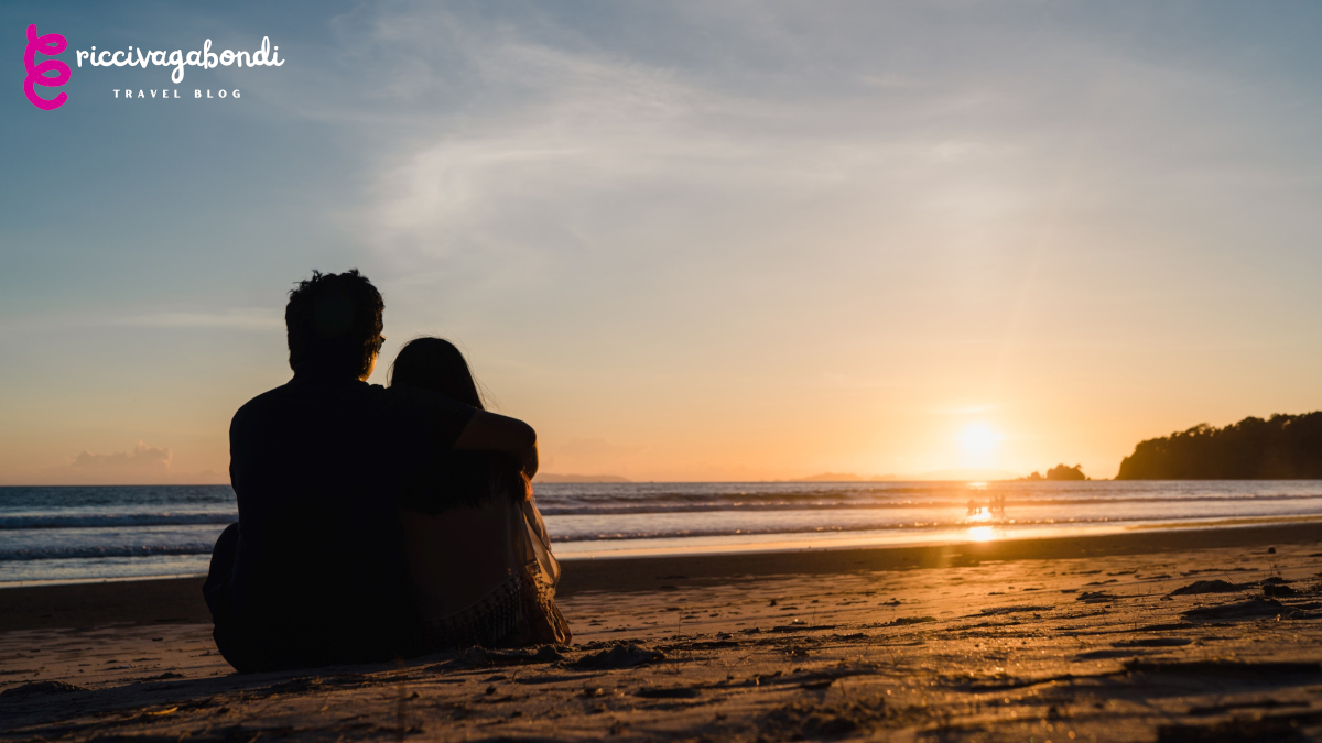 Young Asian couple watching sunset near beach, sweet couple happ