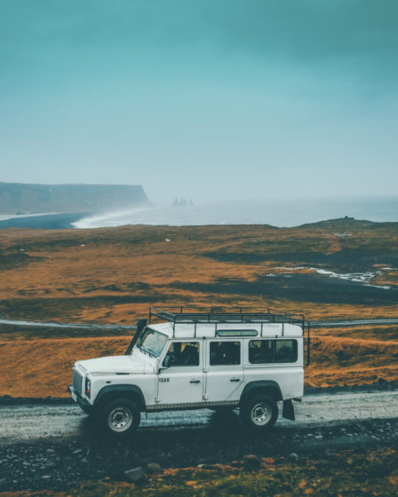 View of a jeep travelling around Island on a rainy day